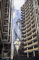 Rectangular steel frame, or "perimeter frame" of the Willis building (at right) contrasted against the diagrid frame at 30 St Mary Axe (at center), in London. Lloyds Axe and Willis.jpg