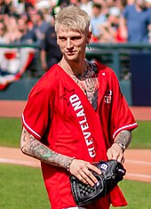 Machine Gun Kelly collaborated with Cabello on her first ever Hot 100 top 5 hit single "Bad Things." MGK (48250880612) (cropped).jpg