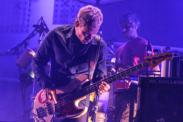 Refosco (back) performing with Flea as part of Atoms for Peace in 2013