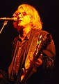 Mike Mills performing in 2009 with R.E.M. backing vocals, bass guitar