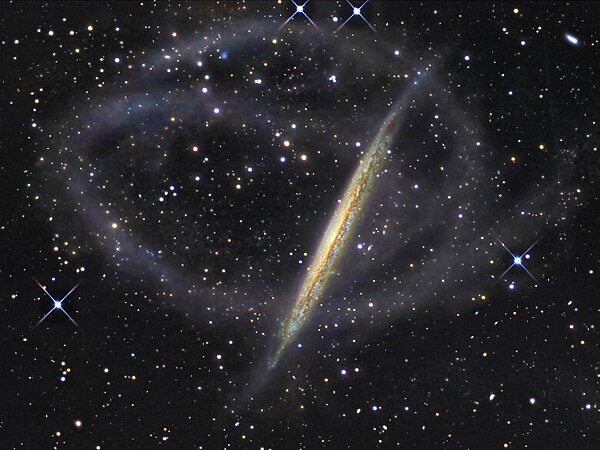 Remnants of a minor merger can be observed in the form of a stellar stream falling onto the galaxy NGC 5907.