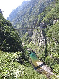 A deep turquoise color of a stream pool on the Piva river. Piva.River-bridge.JPG