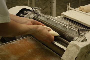 4: The scrolling device roll the dough up into...