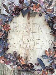 Sign by the west entrance to Regent Gardens Regent Gardens carving.jpg