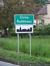 Polnisch-deutsches Ortsschild in Rothhaus (Osiny), Oberschlesien