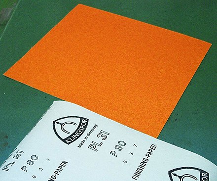 A German Klingspor sandpaper showing its backing and FEPA grit size.