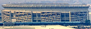 Shea's exterior, pictured here in 1964, was decorated with blue and orange panels from 1964 until their removal in 1980. Shea Stadium exterior 1964.jpg