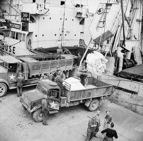 File:Supplies being unloaded from a ship at the Mulberry artificial harbour at Arromanches in Normandy, July 1944. B7231.jpg