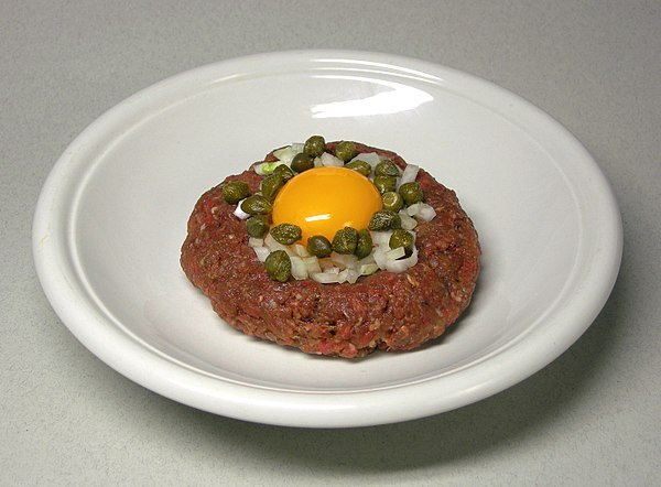 Steak tartare with raw egg, capers and onions