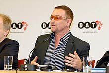 Bono at a 2007 press conference for his NGO DATA The DATA report 2007 press conference with Bono, Herbert Groenemeyer, Bob Geldof, Dr. Ngozi Okonjo-Iweala (499523155).jpg