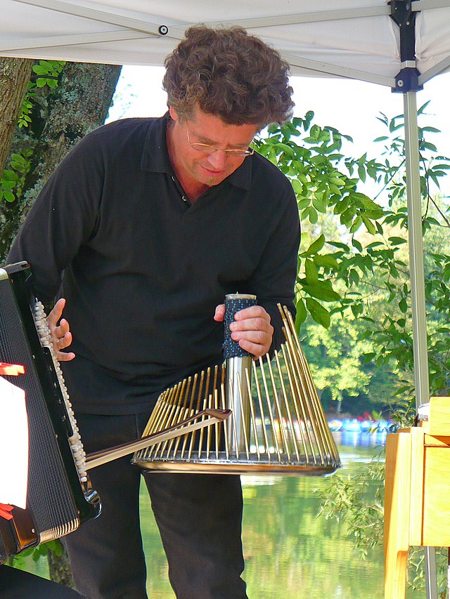  Musician Thomas Bloch playing the waterphone, 19 September 2009 at the Mittersheim pond in France