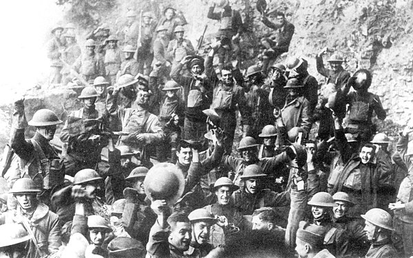 Doughboys of the 64th Infantry Regiment, 7th Division, celebrate the news of the Armistice with Germany, November 11, 1918.