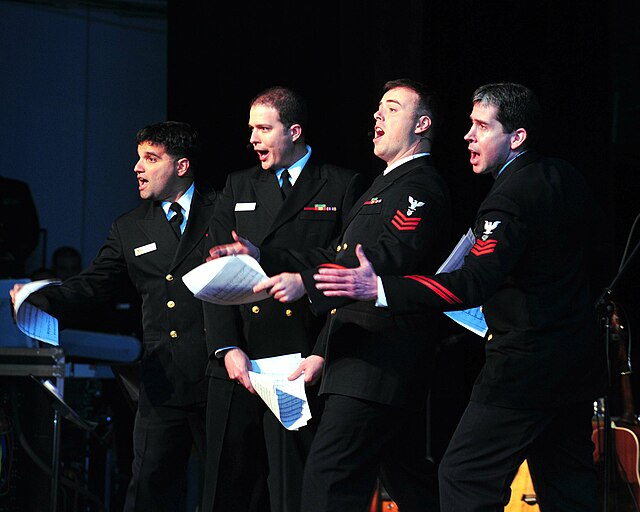 Members of the Navy Sea Chanters sing their comedy version of "The Twelve Days of Christmas" on 4 December 2009, at the Wallace Theater, Ft. Belvoir, 