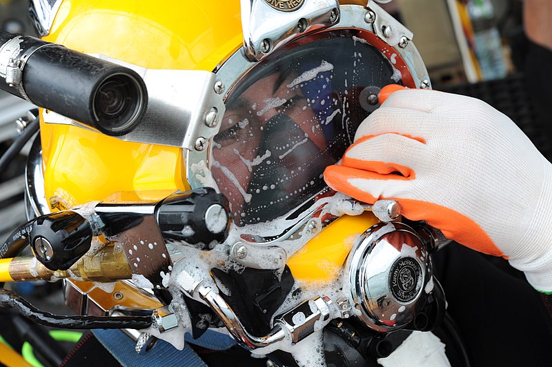 File:US Navy 100527-N-0413B-008 Navy Diver 2nd Class Jessie Trujillo, assigned to Mobile Diving Salvage Unit (MDSU) 1, wipes off cleaning soap from his MK-3 dive helmet glass during pre-dive checks during the Joint POW-MIA Personnel.jpg