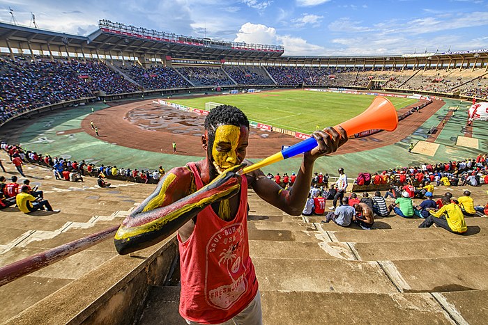 Football fan blowing a trumphet before the Uganda Vs Cape Verde Game.