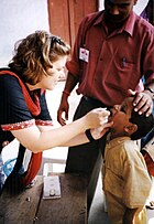 Child receiving oral polio vaccine in India