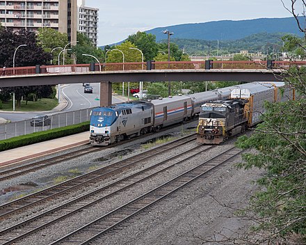 Amtrak's Pennsylvanian entering the Altoona Transportation Center as a Norfolk Southern Railway freight train passes through.