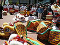 Heads of lion costumes (left) and a dragon costume (right)