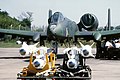 A front view of an A-10 Thunderbolt II aircraft being uploaded with AGM-65 Maverick missiles