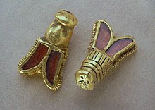 Golden cicadas or bees with garnet inserts, discovered in the tomb of Childeric I (died 482). They may have symbolised eternal life (cicadas) or longevity (the bees of Artemis). Abeilles de Childeric Ier.jpg