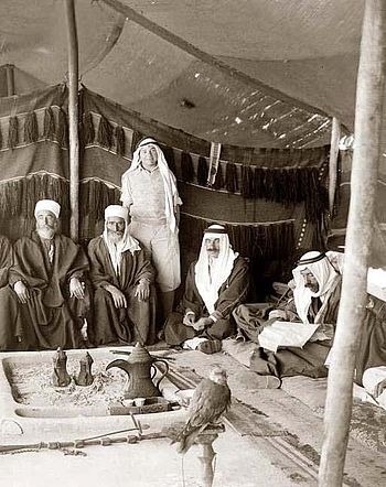 Five men in a traditional tent Arab Tent. They...