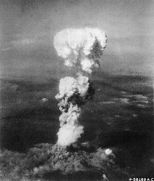 White fragmentred mushroom-like smoke cloud evolving from the ground.