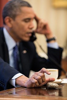 Barack Obama fidgeting with a Petoskey stone while on a phone call (2012) Barack Obama plays with a Petoskey stone.jpg