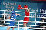 Deutsch: Boxen bei den Olympischen Jugendspielen 2018 Tag 12, 18. Oktober 2018 - Kampf um Bronze im Leichten Weltergewicht Jungen – Hassan Azim (Großbritannien, rot) schlägt Mohammed Boulaouja (Marokko, blau) RSC; Ringrichter ist Wulfren Olivares Peréz (Kolumbien). English: Boxing at the 2018 Summer Youth Olympics on 18 October 2018 – Bronze Medail Match Light Welterweight Boys - Hassan Azim (Great Britain, red) beats Mohammed Boulaouja (Morocco, blue) RSC; Referee is Wulfren Olivares Peréz (Columbia). Español: Boxeo en los Juegos Olímpicos Juveniles de Verano de 2018 en 18 de octubre de 2018 - Medalla de bronce de los hombres ligeros de peso welter: Hassan Azim (Gran Bretaña, rojo) vence a Mohammed Boulaouja (Marruecos, azul) RSC; El árbitro es Wulfren Olivares Peréz (Colombia).