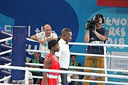 Deutsch: Boxen bei den Olympischen Jugendspielen 2018 Tag 12, 18. Oktober 2018 - Finale Fliegengewicht Mädchen – Martina La Piana (Italien, blau) schlägt Adijat Gbadamosi (Nigeria, rot) 5-0; Ringrichter ist James Beckles (Trinidad und Tobago). English: Boxing at the 2018 Summer Youth Olympics on 18 October 2018 – Girl's flyweight Gold Medal Bout - Martina La Piana (Italy, blue) beats Adijat Gbadamosi (Nigeria, red) 5-0; Referee is James Beckles (Trinidad and Tobago). Español: Boxeo en los Juegos Olímpicos Juveniles de Verano de 2018 en 18 de octubre de 2018 - Combate a medalla de oro de peso mosca para mujeres: Martina La Piana (Italia, azul) le gana a Adijat Gbadamosi (Nigeria, roja) 5-0; El árbitro es James Beckles (Trinidad y Tobago).