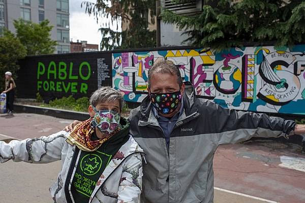 Brad Lander and skateboarding advocate Loren Michelle pose in front of the Pablo Forever Mural at Washington Skatepark in Park Slope on May 8, 2021