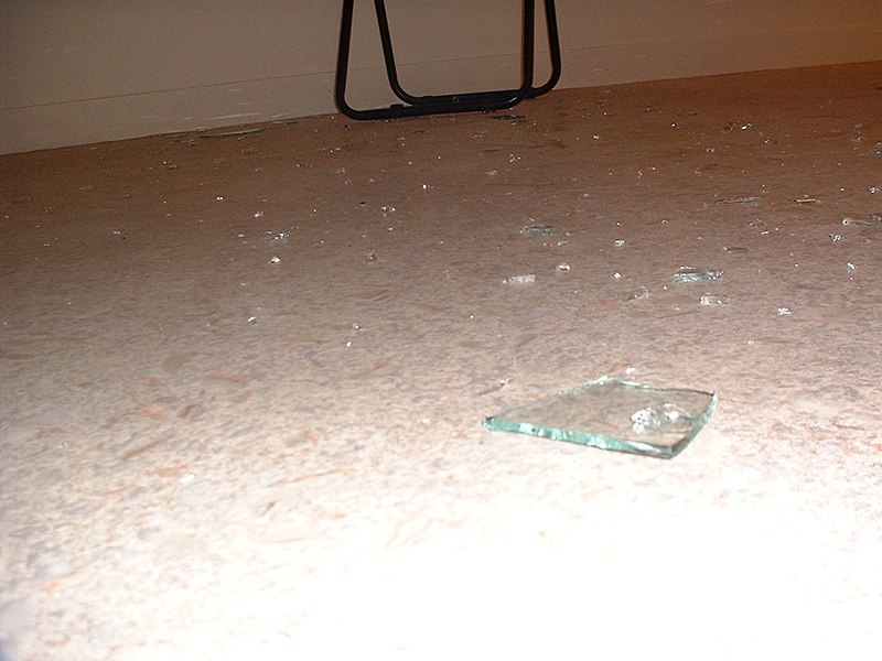 File:Broken window glass on apartment floor after break-in by firefighters due to water leak, Paris 2004.jpg