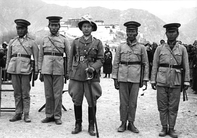 Tibetan soldiers and an army officer at a 1938 New Year's military parade near Lhasa's Potala Palace