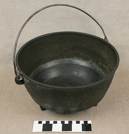 A cast iron cooking pot with bail handle