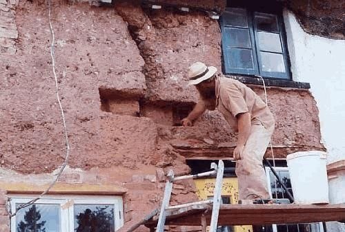 "Cob stitch" repair on old traditional cob cottage in Devon, England