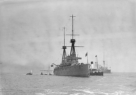 HMS Invincible anchored at Spithead, with on her port broadside the passenger paddle steamer Duchess of Fife HMS 'Invincible' (1907) anchored at Spithead. RMG P00035.jpg