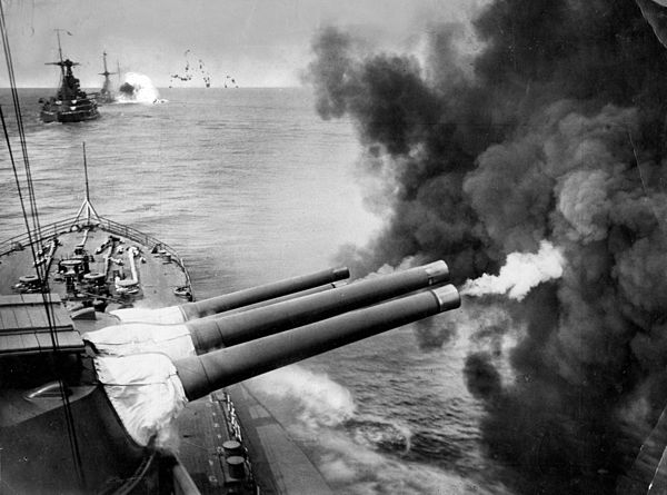 BL 15-inch Mk I naval guns firing, interwar view of a Queen Elizabeth-class battleship - the right-hand gun in each turret has just fired and the degr