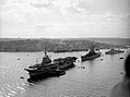 HMS Warrior (R31), USS Des Moines (CA-134) and HMS Gambia (48) at Malta, circa in 1951 (IWM A32043).jpg
