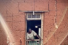 A December morning in Isoyin. A matriarch overseeing morning meal preparations IMG4860-Onalaja.jpg