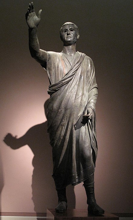 The Orator, ca. 100 BC, an Etrusco-Roman bronze sculpture depicting Aule Metele (Latin: Aulus Metellus), an Etruscan man of Roman senatorial rank, engaging in rhetoric. The statue features an inscription in the Etruscan alphabet