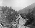 Man next to ore cart on tracks, Cascade Mountains, ca 1889-1890 (WASTATE 2424).jpeg