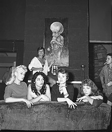 Beatniks posing in front of a piece of beatnik art, 1959. The Beat Generation are seen as a predecessor to the hippie movement Miss Beatnik of 1959 contestants.jpg