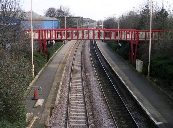 New Pudsey station seen from the road bridge of Owlcotes Lane with footbridge and access ramps to platforms in March 2007