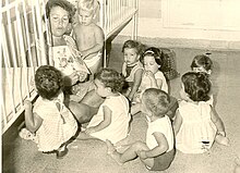 Kibbutz Afikim children with their nanny at the children's house. Mid 1960s. Nurse with kibbutz children.jpg