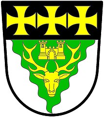 Lydney Rural District Council (abolished 1974): Argent, on a pile wavy throughout vert, a stag's head caboshed, between the attires a port between two towers, or; on a chief sable three crosses formy or.