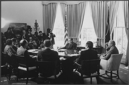 A meeting of Nixon Administration economic advisors and cabinet members on May 7, 1974. Clockwise from Richard Nixon: George P. Shultz, James T. Lynn, Alexander M. Haig, Jr., Roy L. Ash, Herbert Stein, and William E. Simon.