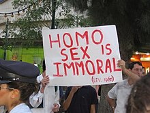 Religious protestors at a pride parade in Jerusalem, with a sign that reads, "Homo sex is immoral (Lev. 18/22)". The association of homosexual sex with immorality or sinfulness is seen by many as a homophobic act. Protestors at a pride parade in Jerusalem with sign that reads, "Homo sex is immoral (Lev. 18-22)".jpg