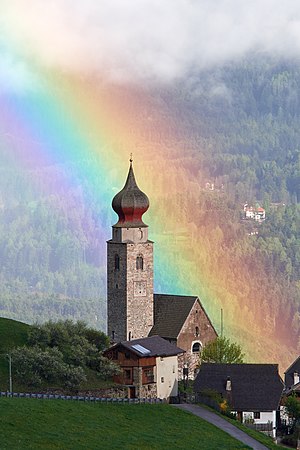 One of the cases of being at the right place at the right time while having the camera and the right lens with me. The picture shows the St. Nikolaus Church in Mittelberg on the Ritten plateau, just before a huge thunderstorm. My first images had the strong rainbow, but with the church still in the shadow, but luckily the sky opened a bit further, placing the church in the limelight.