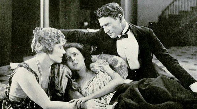 Film still of Gertrude Astor, Moore, and Richard Dix from The Wall Flower (1922)