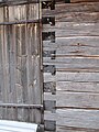 A locked or tooth-edge joint in the door corner of an old wooden storage building at the Lamminaho estate in Vaala, Finland.