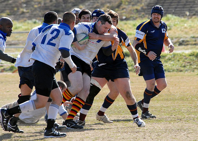 File:US Navy 090208-N-6523K-369 Cmdr. Greg McGuire, a center for the aircraft carrier USS George Washington (CVN 73) Rugby Football Club, pushes into a maul during a game.jpg